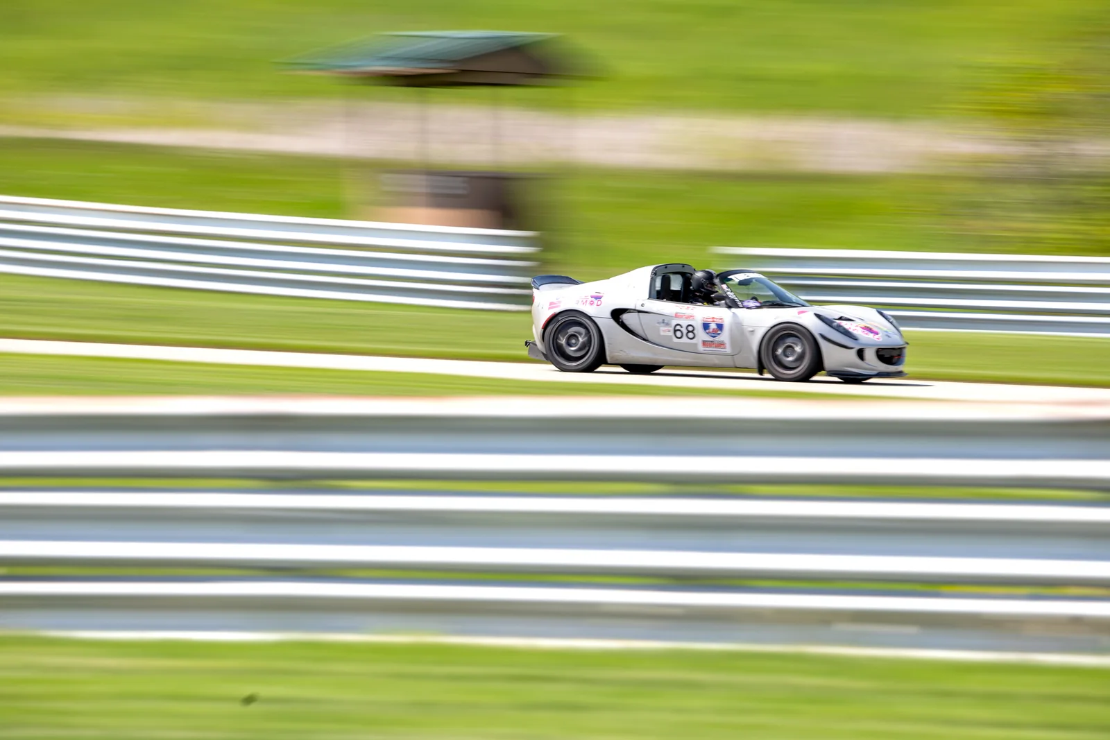 White Dadbod Carmod Lotus Elise number 68 moving at speed on track