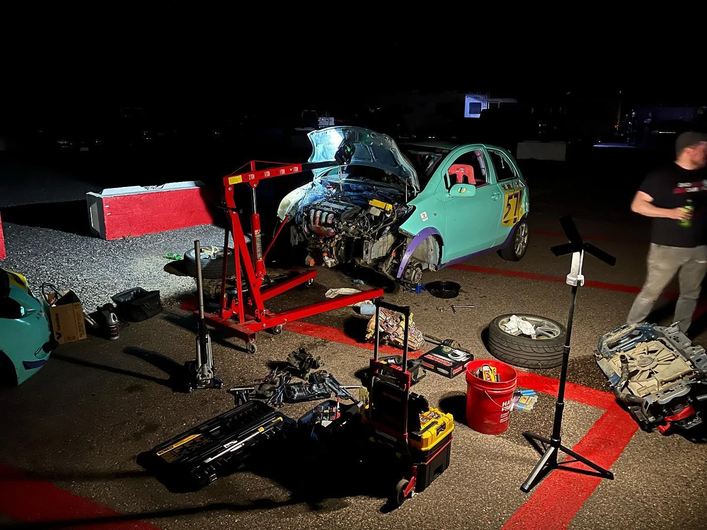 Turquoise number 57 Yaris raised for nighttime paddock repairs
