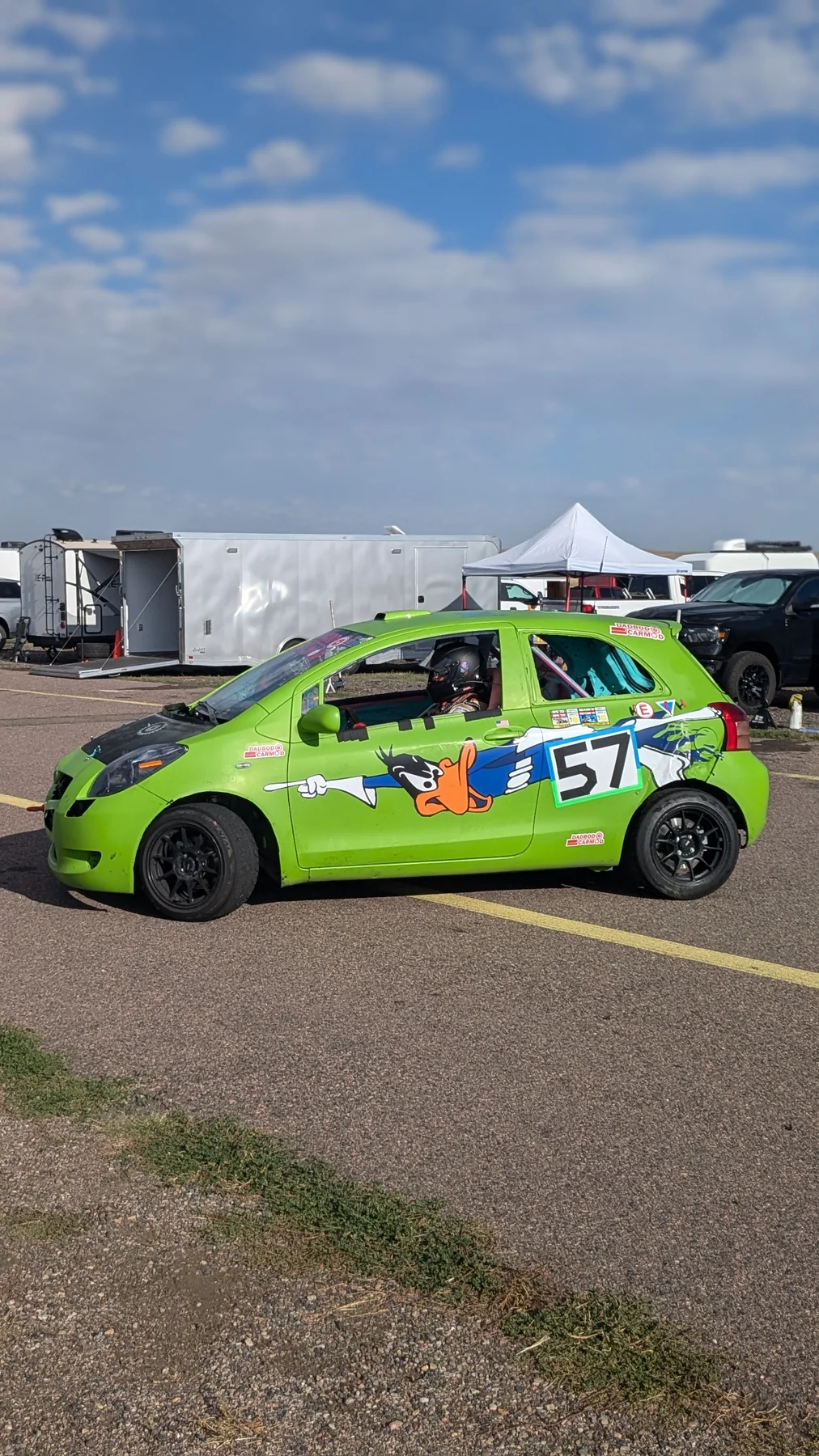 Green number 57 Yaris in the paddock