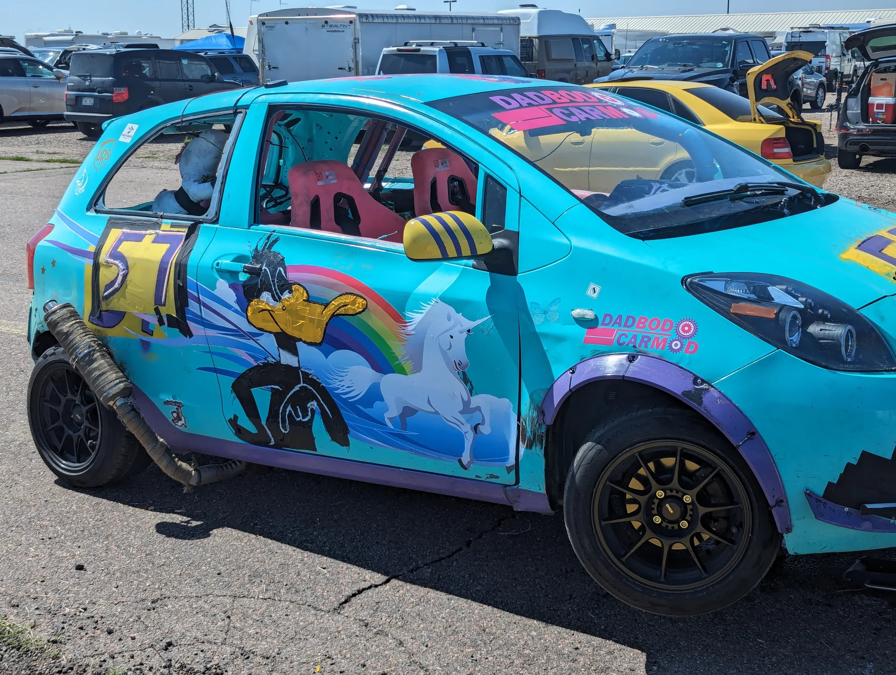 Turquoise number 57 Yaris showing its full illustrated livery